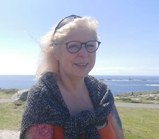 Rosalind Fairclough smiling, with the sea behind her.